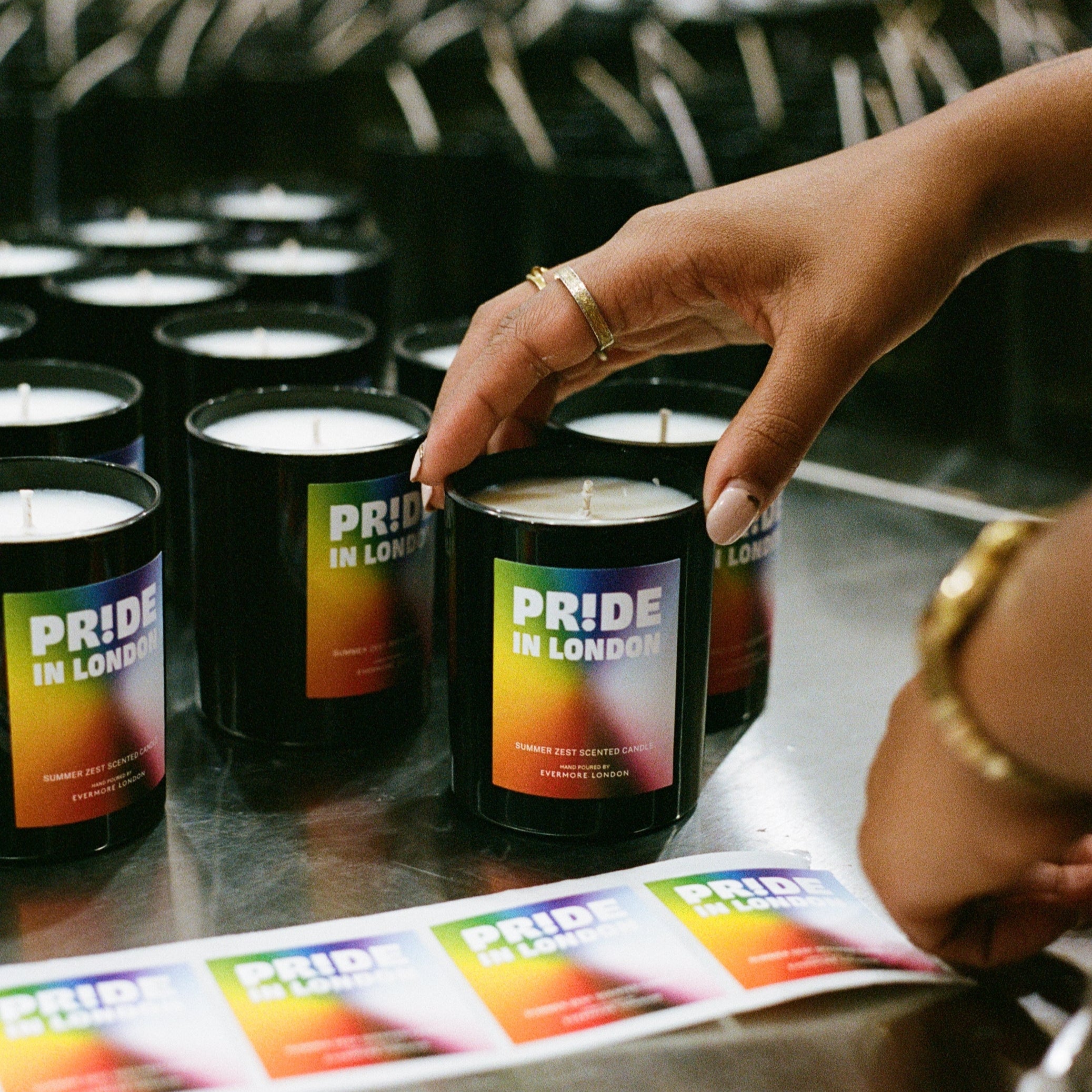 Person holding a Pride-themed product with colorful packaging.